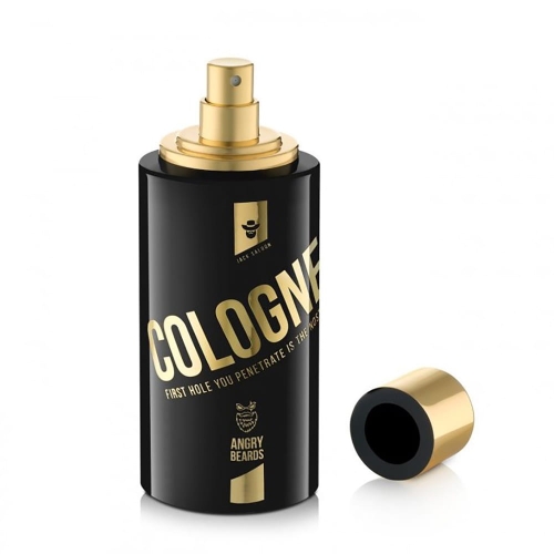 Czarna butelka wody kolońskiej Angry Beards Jack Saloon 100 ml z złotą metalową nakrętką i napisem COLOGNE oraz logo potwora. Butelka stoi pionowo, nakrętka obok, na białym tle podkreślającym elegancję.