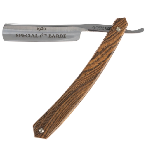 Brzytwa Thiers Issard ze stali nierdzewnej, rączka z drewna bocote w ciepłym brązie z wyraźnym rysem. Oznaczenia SPECIAL 1ère BARBE i 1920. Położona poziomo na jasnym tle, podkreśla elegancję i detale.