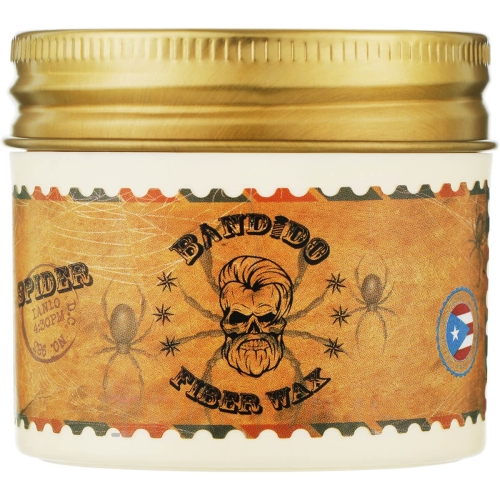 Wosk do włosów Bandido Fiber w pojemniku 125 ml, z nadrukiem w odcieniach pomarańczowego i brązu, przedstawiający czaszkę z brodą, logo i pająki na tle sieci. Pojemnik z metalową zakrętką, ustawiony na białym tle.