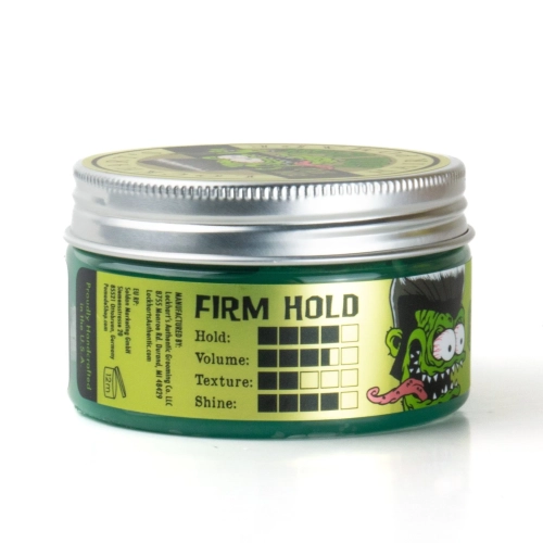 Pomada woskowa Lockhart's Goon Grease 96g w zielonym opakowaniu z metalową nakrętką. Widoczne napisy: FIRM HOLD, Volume, Texture, Shine oraz rysunek potwora. Białe tło podkreśla kolor produktu.