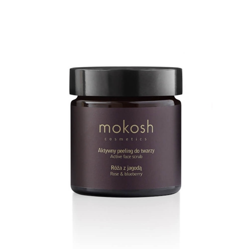 Słoiczek 150 ml peelingu do twarzy Mokosh, z czarną zakrętką i etykietą w brązowo-złotych odcieniach, opisany jako „Róża z jagodą” i oznaczony tekstem „Active face scrub” na białym tle.