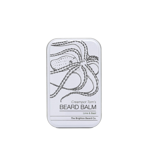 Biały pojemnik balsamu do brody Creampot Tom's BEARD BALM z nadrukiem ośmiornicy, czerwonym napisem Lime & Basil i logo The Brighton Beard Co., pochylony z przodu.