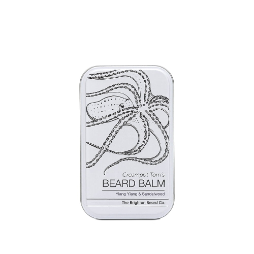 Metalowa puszka białego balsamu do brody z czarnym wzorem ośmiornicy, napisem „CREAMPOT TOM'S BEARD BALM” i podtytułem „Ylang Ylang & Sandalwood” na frontowej stronie, stojąca pionowo na jednolitym tle.